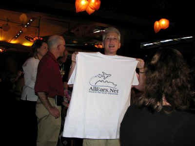 Deb Wills unveils the new AllEars logo, designed by our own Frogman.