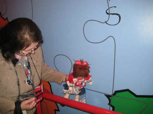 "Pseudo-Tacey" is pointing out her home town on this giant map!  She lives in the big blue country!