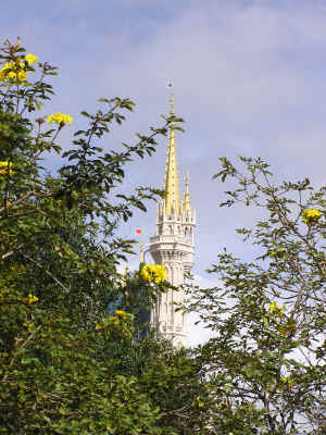 A spire of Cinderella Castle shot from the entrance to Adventureland